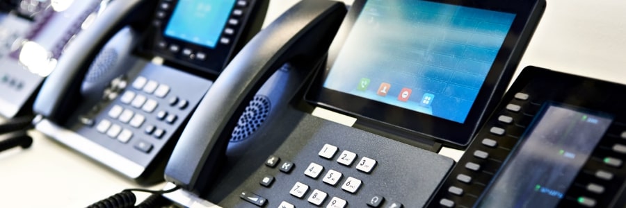 A row of office desk phones